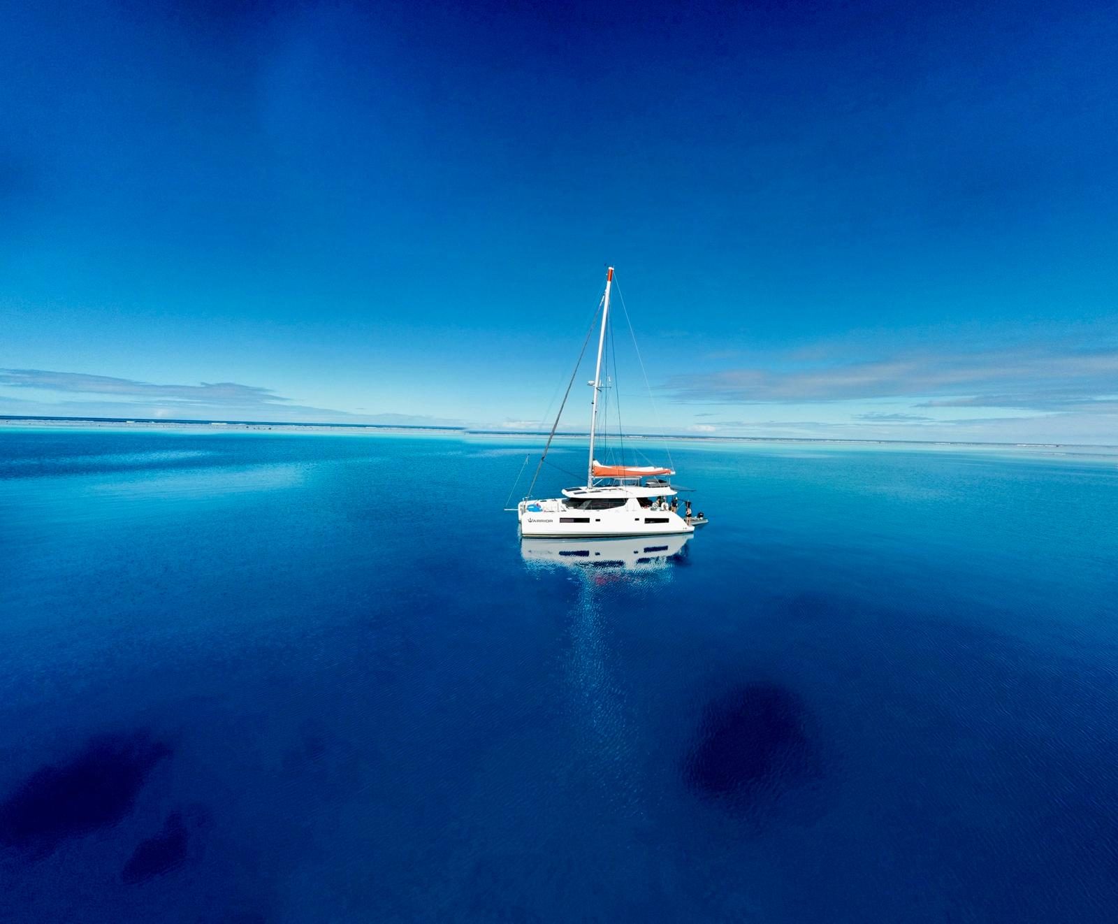WARRIOR, the family's Leopard 45, at rest in tropical water.